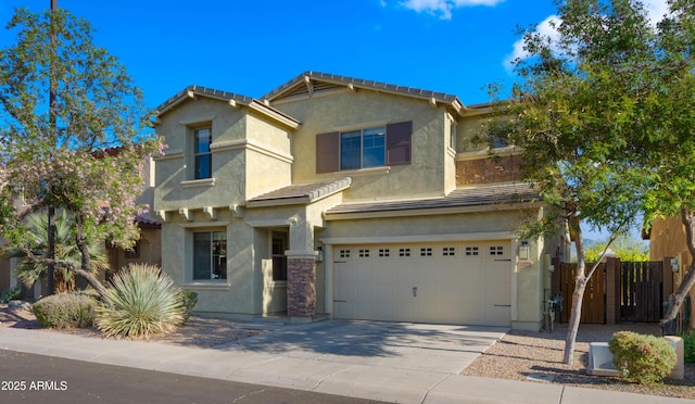 traditional-style house with an attached garage, stucco siding, concrete driveway, fence, and a tile roof