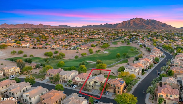 aerial perspective of suburban area featuring a mountain backdrop, property boundaries highlighted, and a golf course