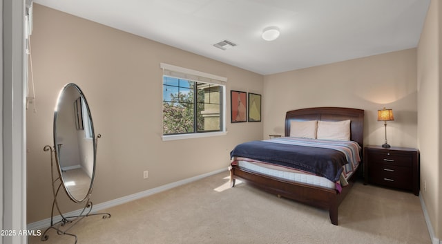 bedroom featuring light colored carpet and baseboards