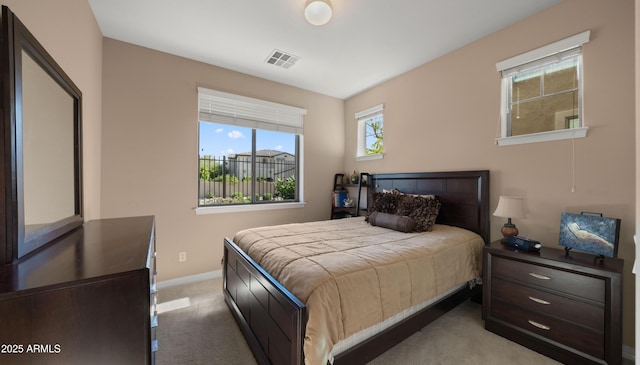 bedroom featuring light carpet and baseboards