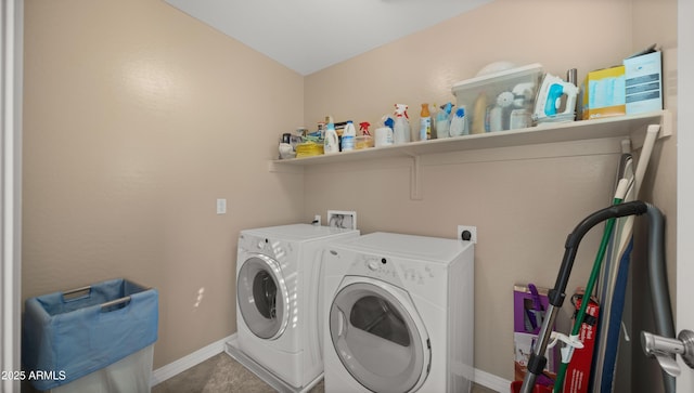clothes washing area featuring washing machine and clothes dryer and baseboards