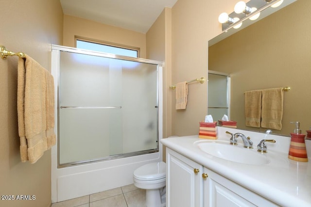 19607 N Flint Way, Surprise, AZ 85374 - bathroom with vanity, toilet, tile patterned flooring, and bath / shower combo with glass door