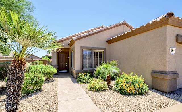 19607 N Flint Way, Surprise, AZ 85374 - entrance to property featuring stucco siding, a tiled roof, and an attached garage