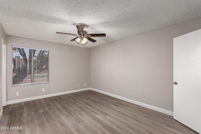 spare room featuring a textured ceiling, dark hardwood / wood-style floors, and ceiling fan