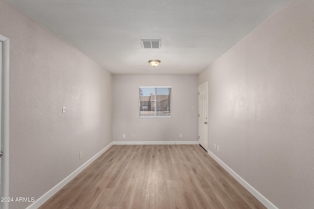 empty room with light hardwood / wood-style flooring