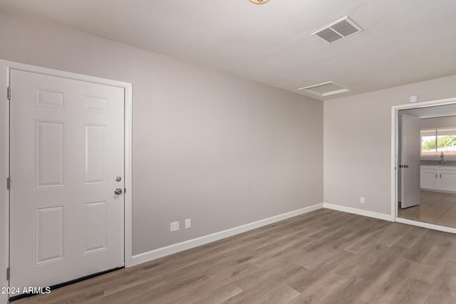 spare room featuring light wood-type flooring and sink