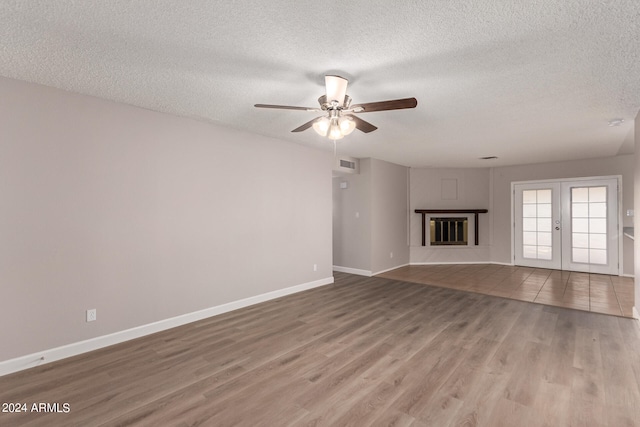 unfurnished living room featuring a textured ceiling, light hardwood / wood-style floors, and ceiling fan