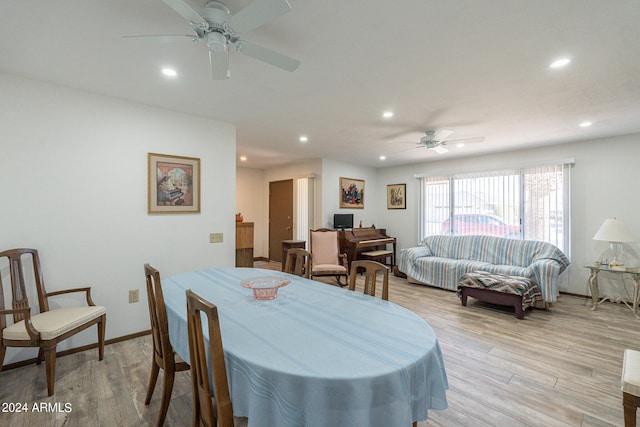 dining area with ceiling fan and light hardwood / wood-style floors