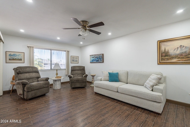 living room featuring dark wood-type flooring and ceiling fan