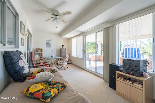 interior space featuring a healthy amount of sunlight, ceiling fan, and light colored carpet