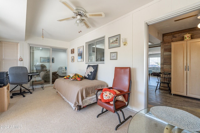 bedroom featuring wooden walls, ceiling fan, a closet, and dark hardwood / wood-style flooring