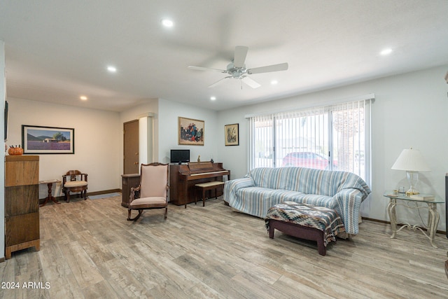 living room featuring light wood-type flooring and ceiling fan