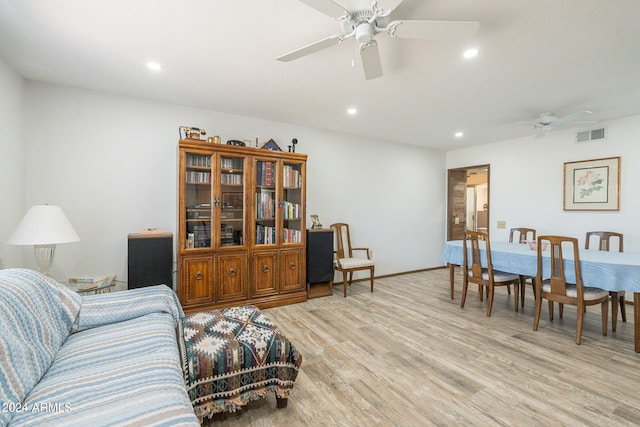 living room with light wood-type flooring and ceiling fan