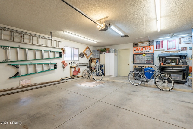 garage with a garage door opener and a workshop area