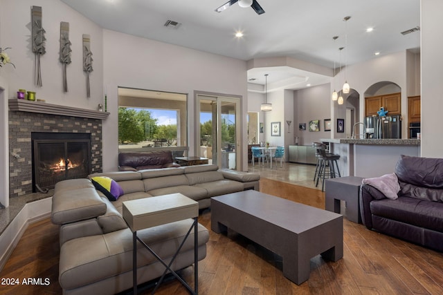 living room featuring dark wood-type flooring and a towering ceiling