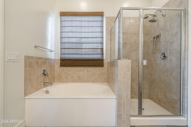 bathroom with shower with separate bathtub