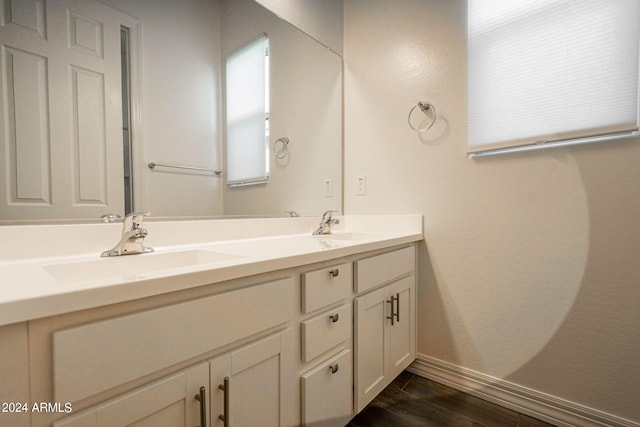 bathroom with hardwood / wood-style floors and vanity