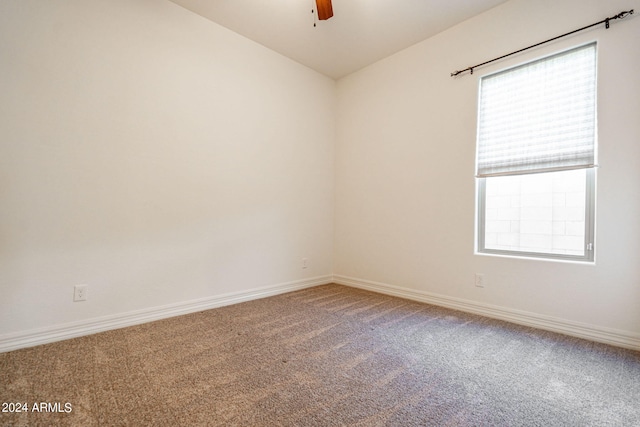 unfurnished room featuring ceiling fan, carpet, and vaulted ceiling