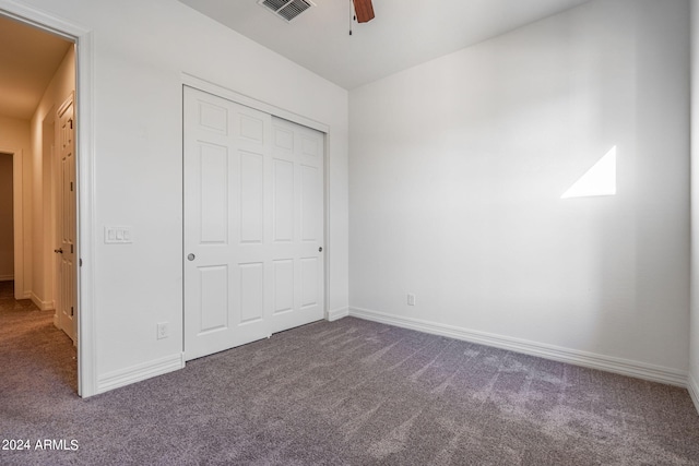 unfurnished bedroom with ceiling fan, carpet floors, and a closet