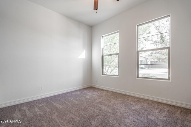 spare room with ceiling fan and carpet