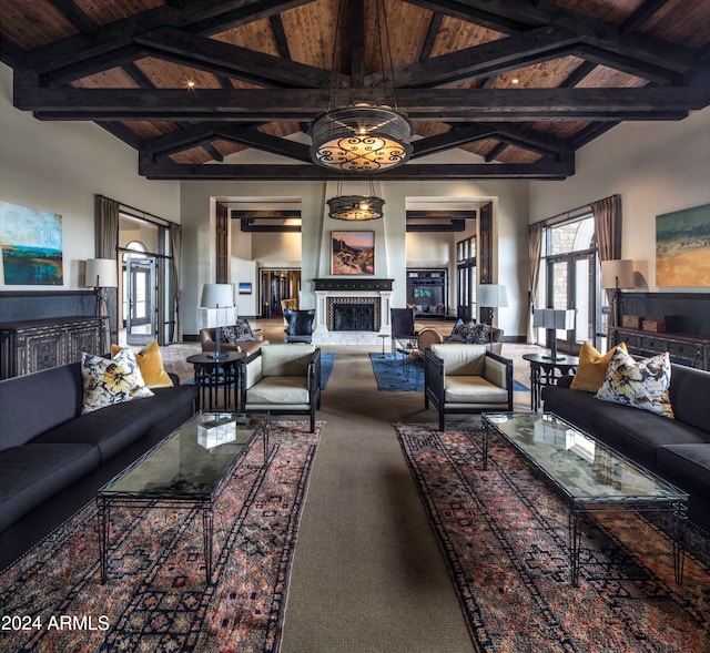 carpeted living room featuring beam ceiling, high vaulted ceiling, and wood ceiling