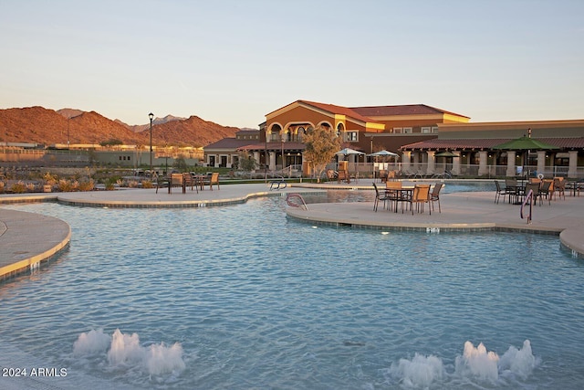 view of swimming pool featuring a mountain view and a patio area