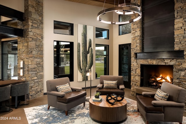 interior space with a towering ceiling and a stone fireplace