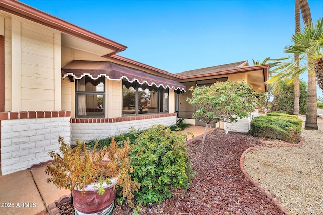 exterior space with brick siding