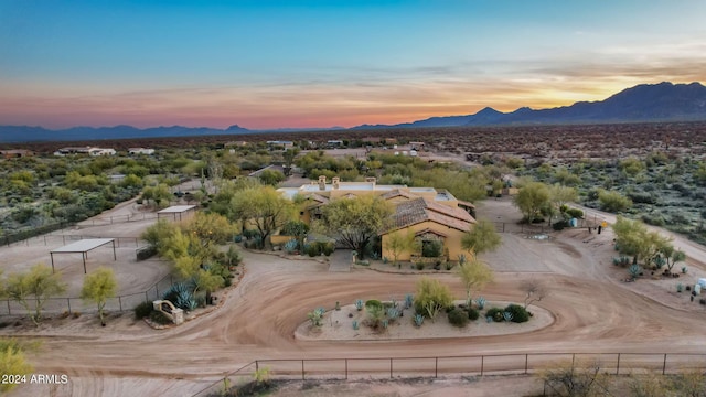 aerial view at dusk featuring a mountain view