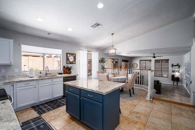 kitchen with a sink, blue cabinetry, black dishwasher, lofted ceiling, and visible vents