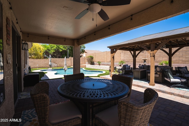 view of patio featuring a fenced backyard, an outdoor hangout area, a fenced in pool, a ceiling fan, and a gazebo