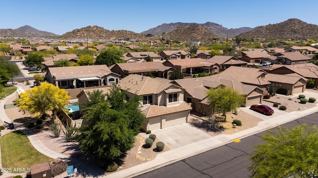 drone / aerial view featuring a residential view and a mountain view