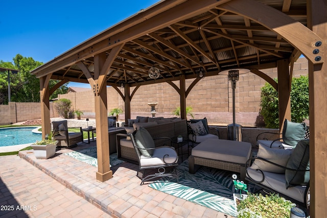 view of patio / terrace featuring an outdoor hangout area, a gazebo, and a fenced backyard