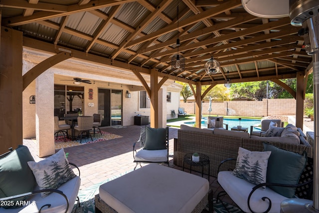 view of patio / terrace with fence, a gazebo, a fenced in pool, an outdoor living space, and a ceiling fan