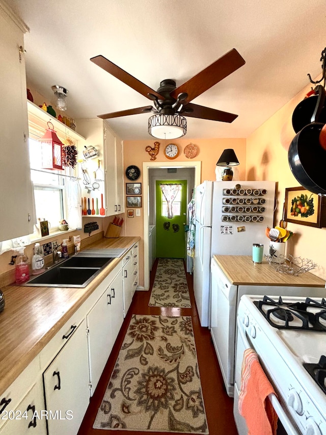 kitchen with white cabinetry, sink, and a wealth of natural light