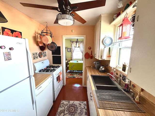 kitchen featuring white cabinetry, sink, ceiling fan with notable chandelier, and white appliances