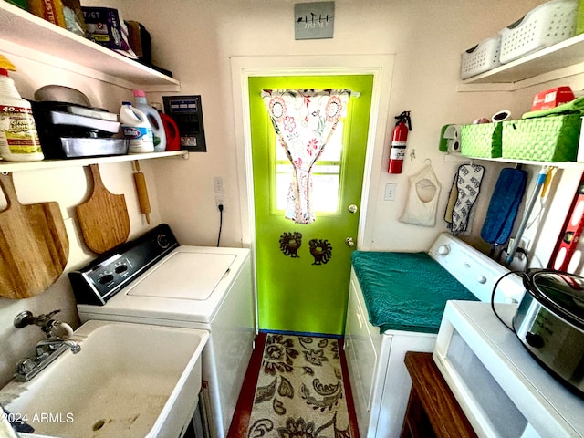 laundry room with independent washer and dryer and sink