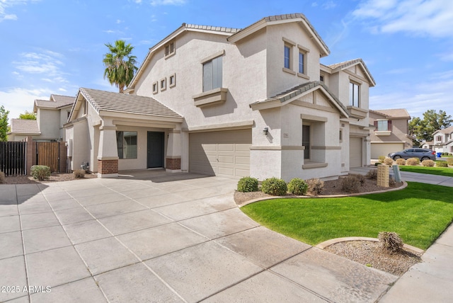 view of front of property with an attached garage, fence, driveway, a tiled roof, and stucco siding