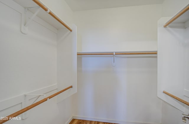 walk in closet featuring wood finished floors