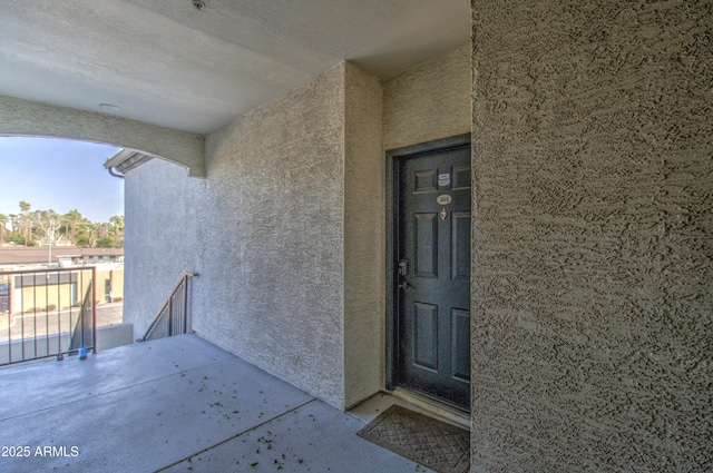 doorway to property featuring stucco siding