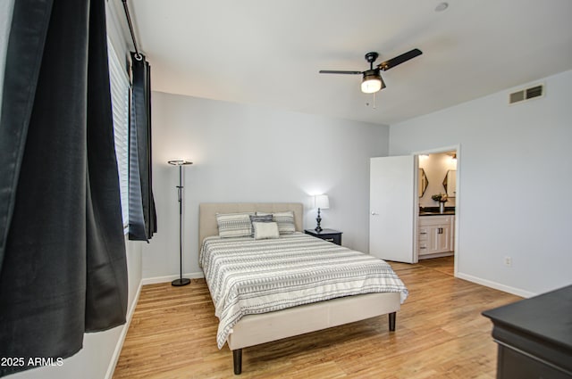 bedroom with baseboards, visible vents, and light wood finished floors