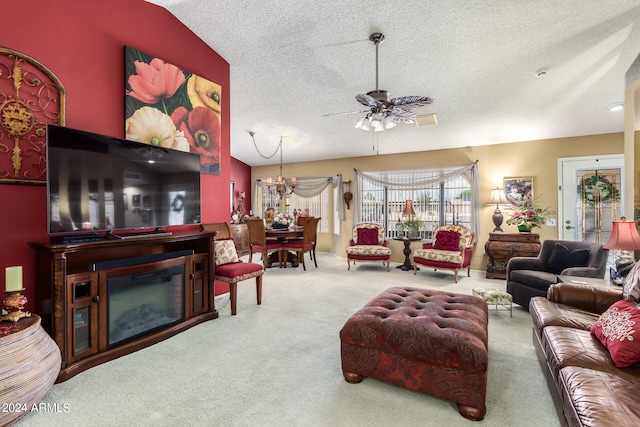 living room featuring ceiling fan with notable chandelier, vaulted ceiling, carpet floors, and a textured ceiling