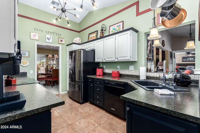 kitchen featuring white cabinets, stainless steel refrigerator, vaulted ceiling, a textured ceiling, and black dishwasher