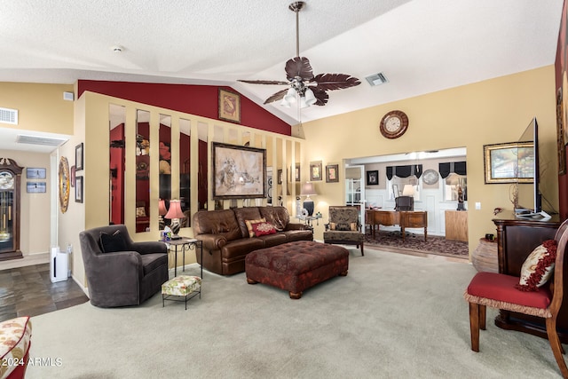 living room with ceiling fan, vaulted ceiling, carpet floors, and a textured ceiling