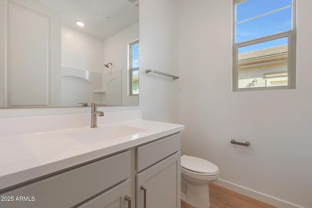 bathroom with vanity, toilet, a shower, and hardwood / wood-style flooring