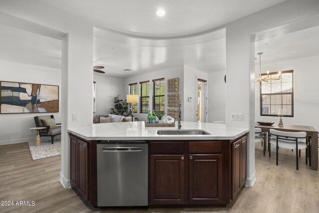 kitchen featuring dishwasher, sink, kitchen peninsula, light hardwood / wood-style flooring, and dark brown cabinetry