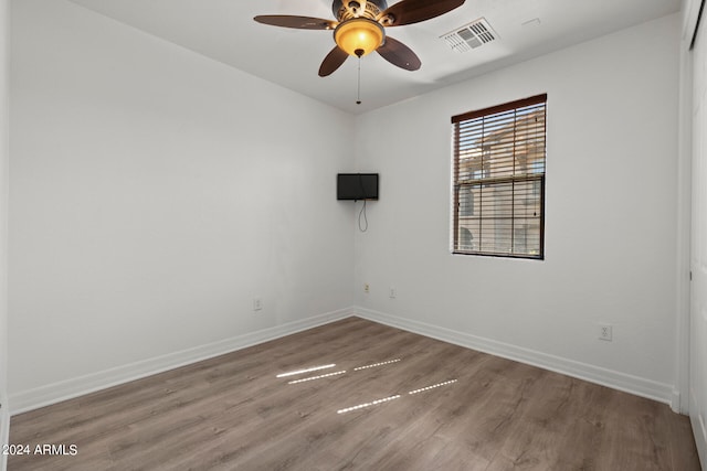 spare room with ceiling fan and hardwood / wood-style floors