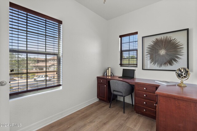 office with light wood-type flooring