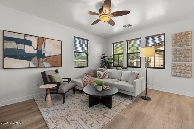 living room with ceiling fan and light hardwood / wood-style floors