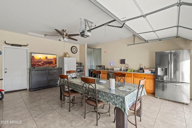 tiled dining room with ceiling fan